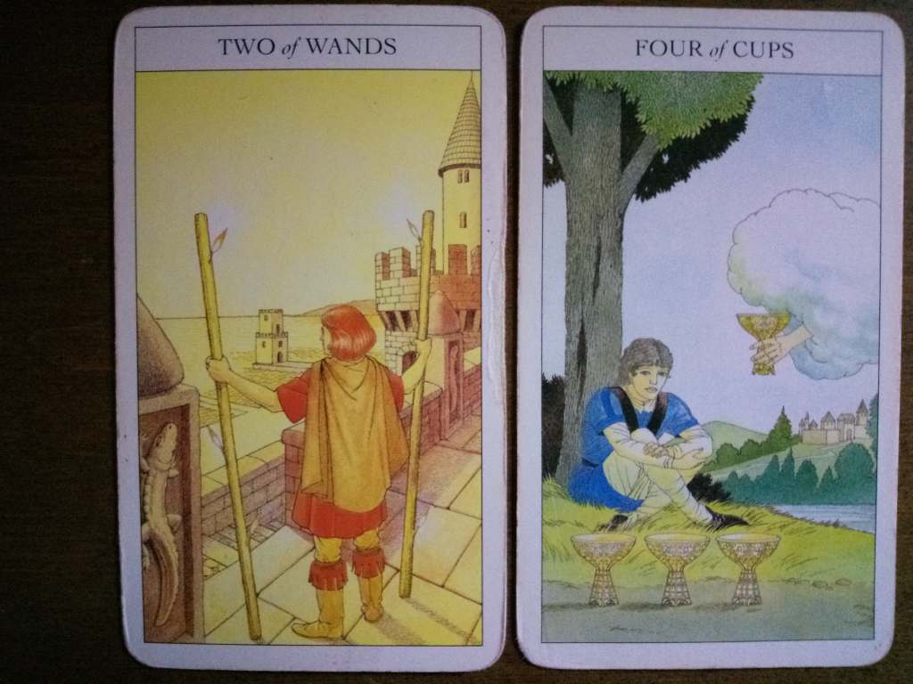 Two tarot cards, the Two of Wands and Four of Cups.